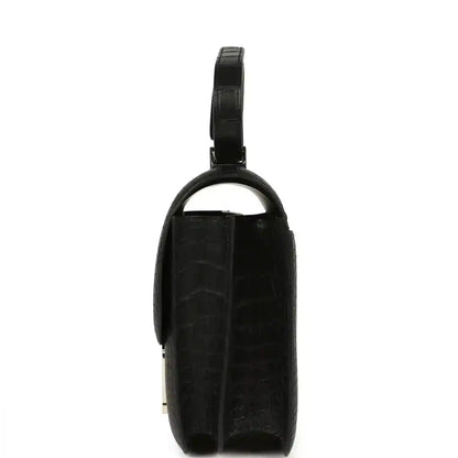 Black crocodile-pattern handbag with top handle and slim side profile