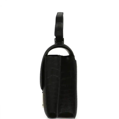 Black crocodile-pattern handbag with top handle and slim side profile