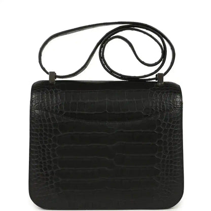 Black crocodile-pattern flap bag with top handle and shoulder strap