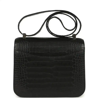 Black crocodile-pattern flap bag with top handle and shoulder strap
