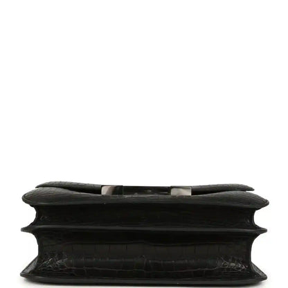 Black crocodile-pattern bag underside with structured edge