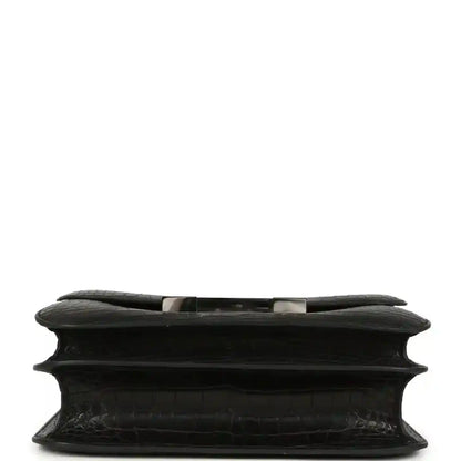 Black crocodile-pattern bag underside with structured edge