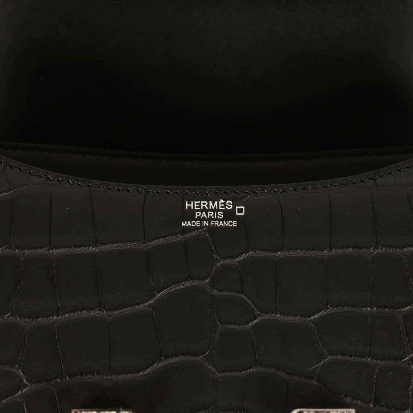 Hermes Paris label inside black crocodile-pattern bag