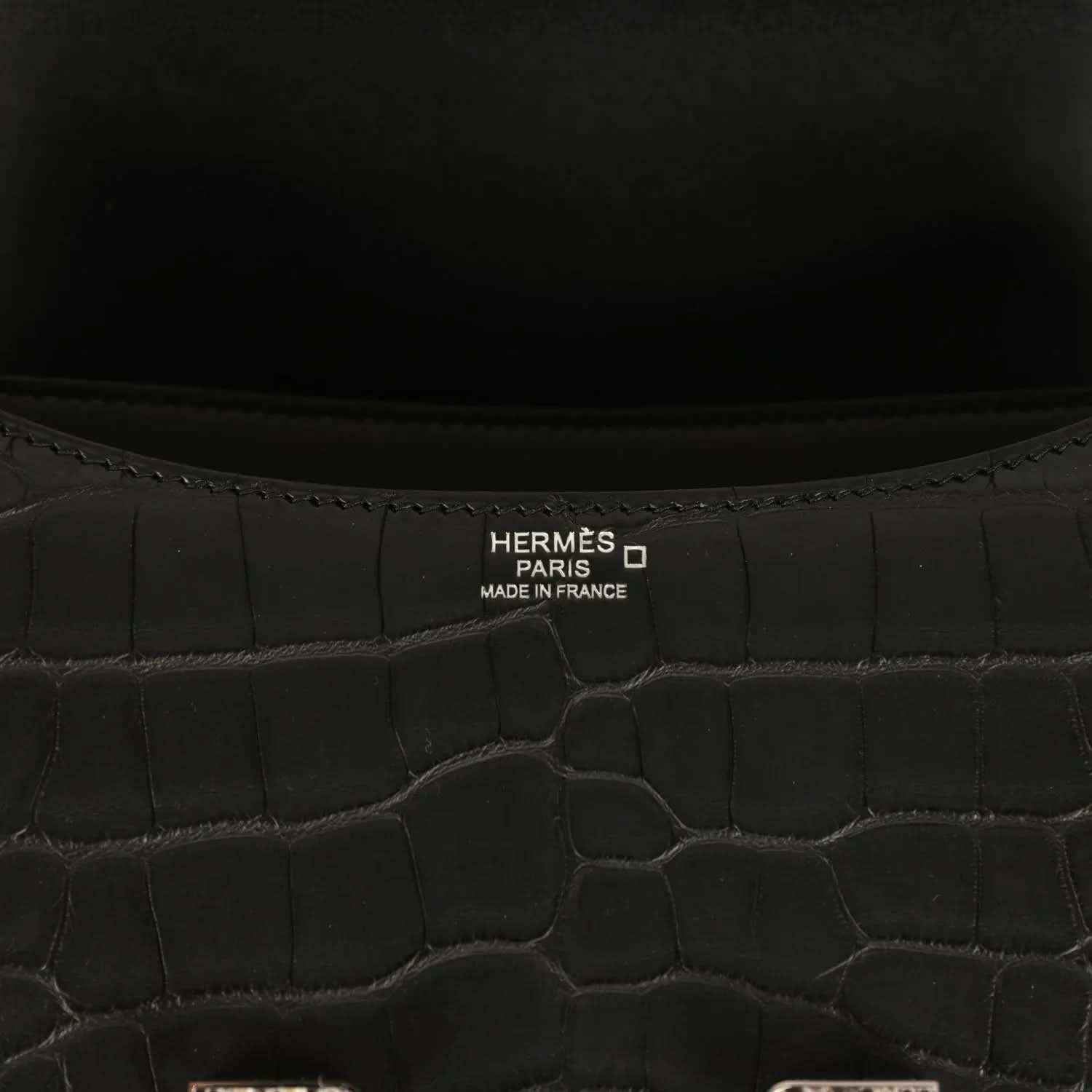Hermes Paris label inside black crocodile-pattern bag
