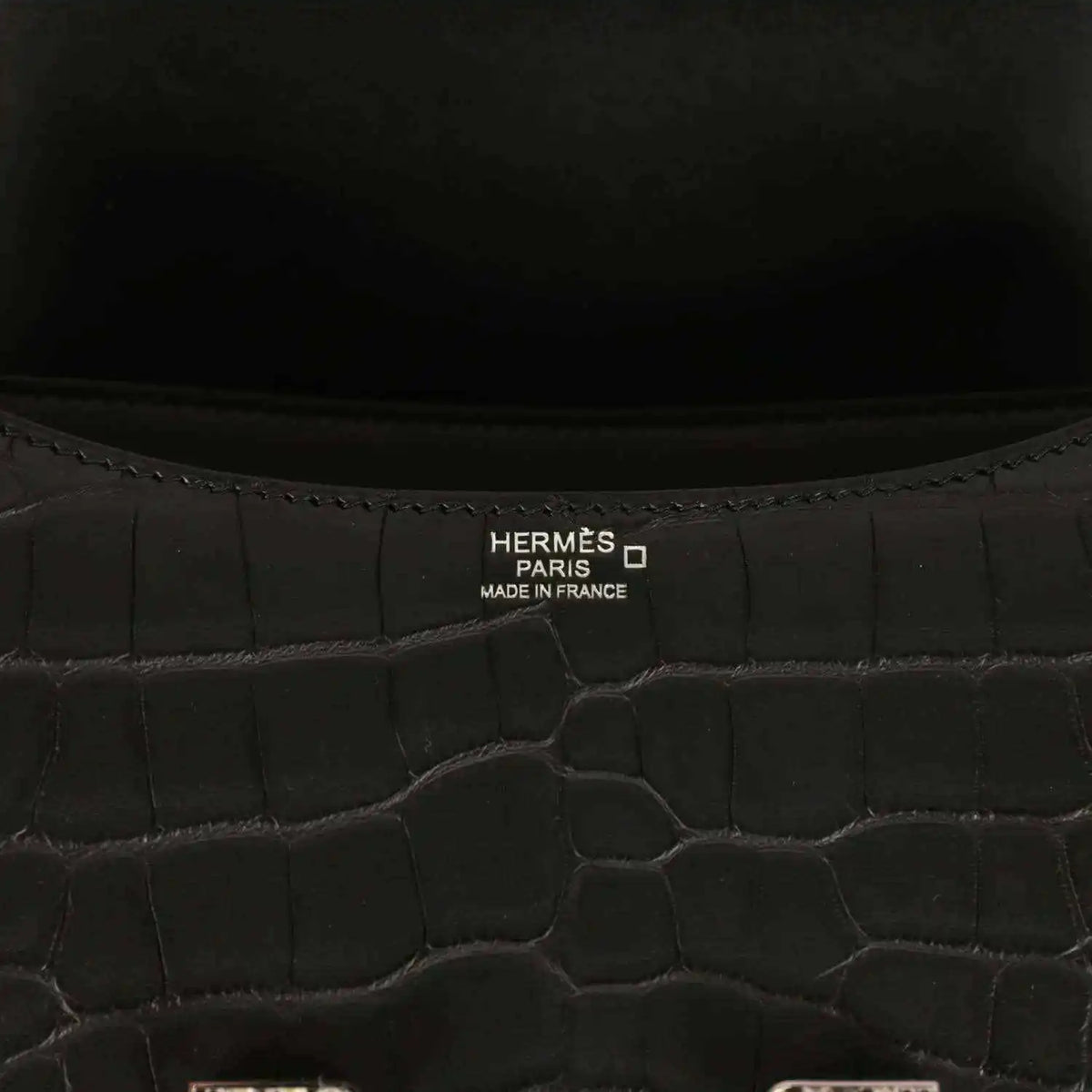 Hermes Paris label inside black crocodile-pattern bag