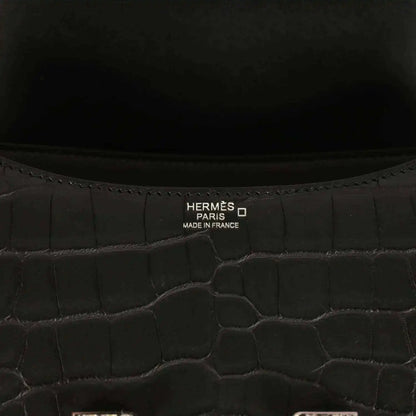 Hermes Paris label inside black crocodile-pattern bag