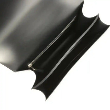 Black fabric interior lining with stitched piping on the bag