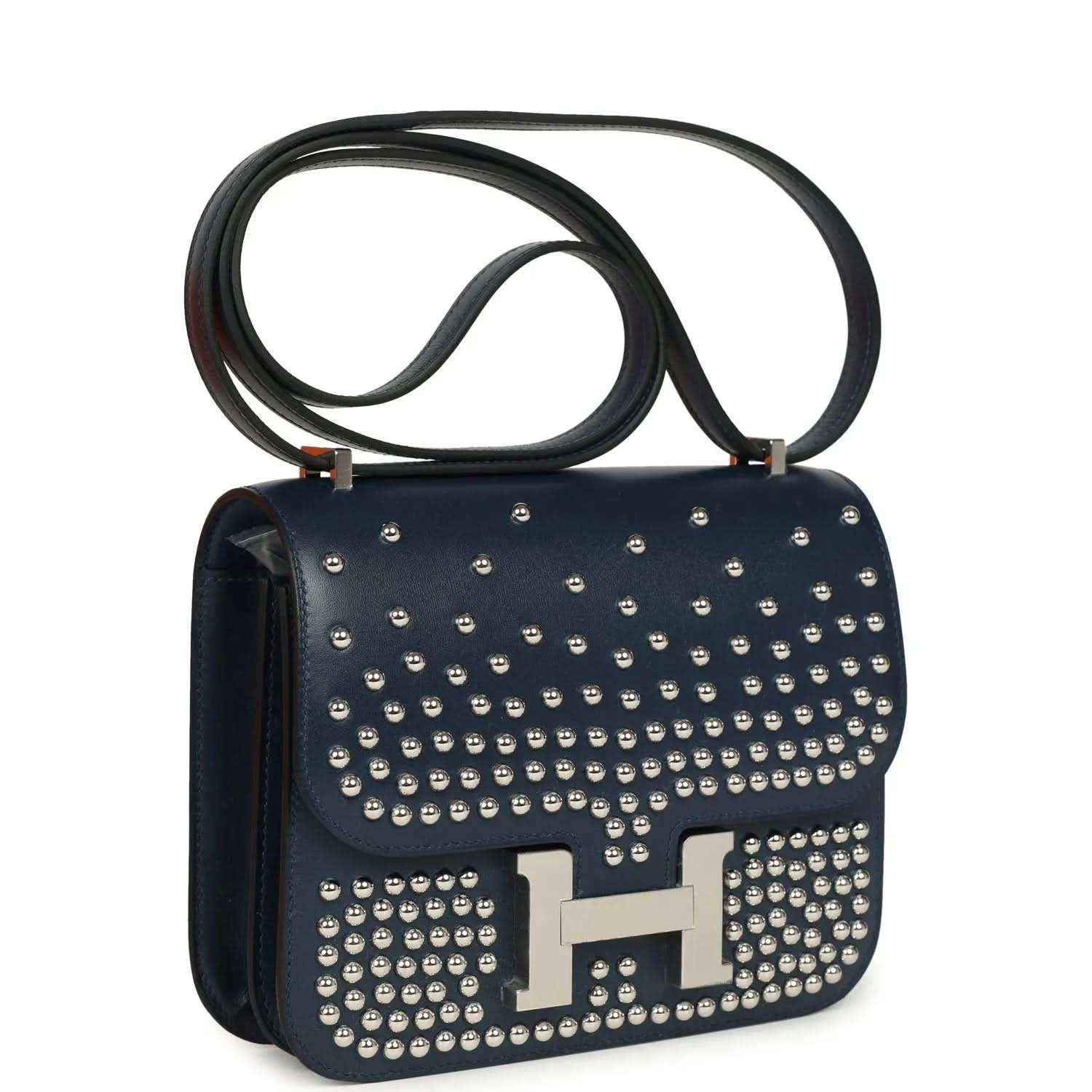 Blue studded leather flap bag with H clasp, side view, and palladium-tone hardware