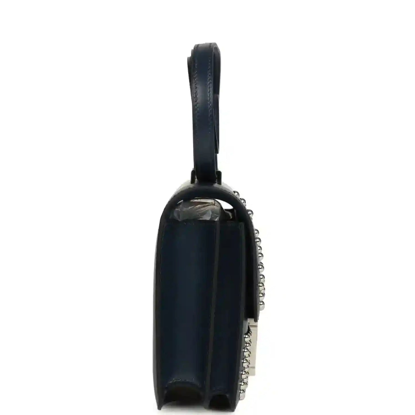 Blue leather crossbody bag with top handle, side view, and silver-tone chain detail