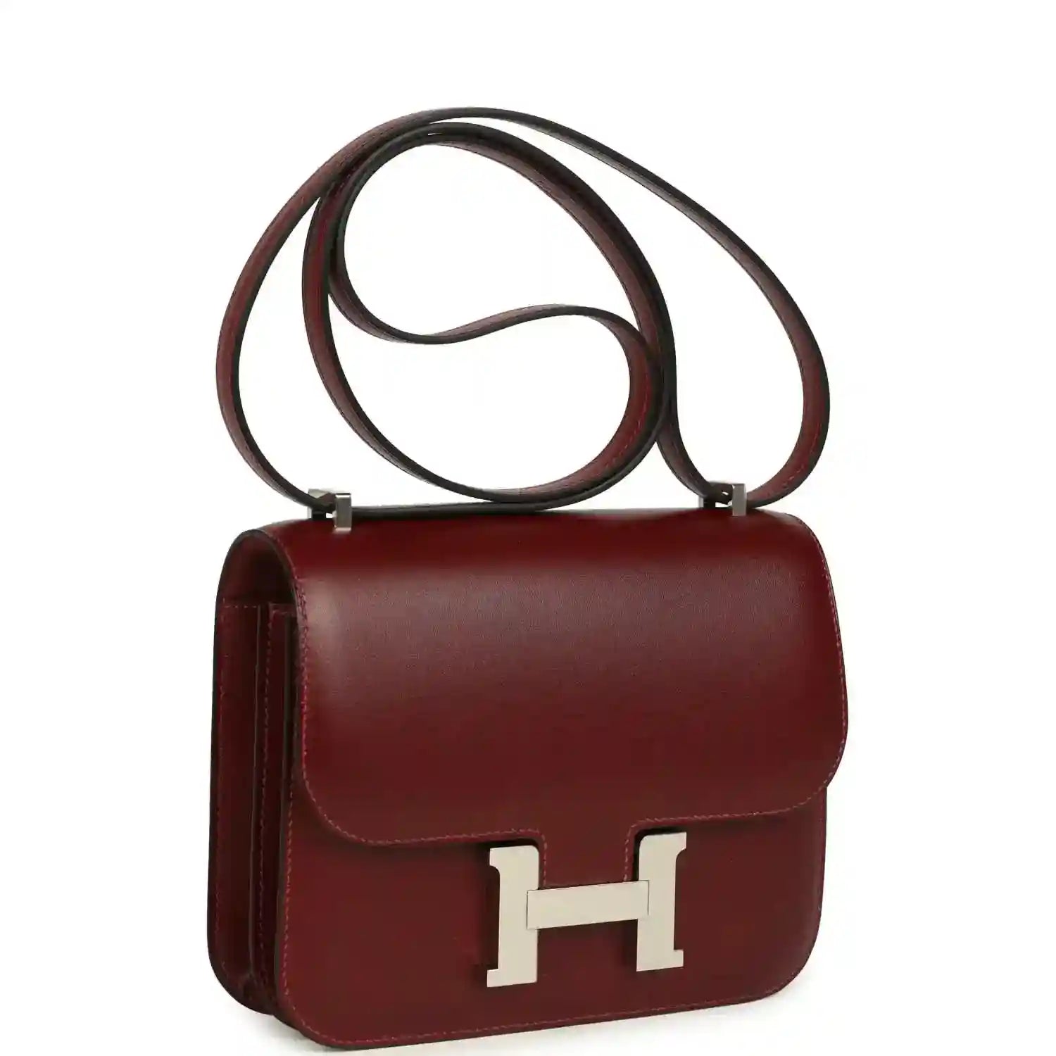 Burgundy leather flap bag with long strap and silver H logo clasp.