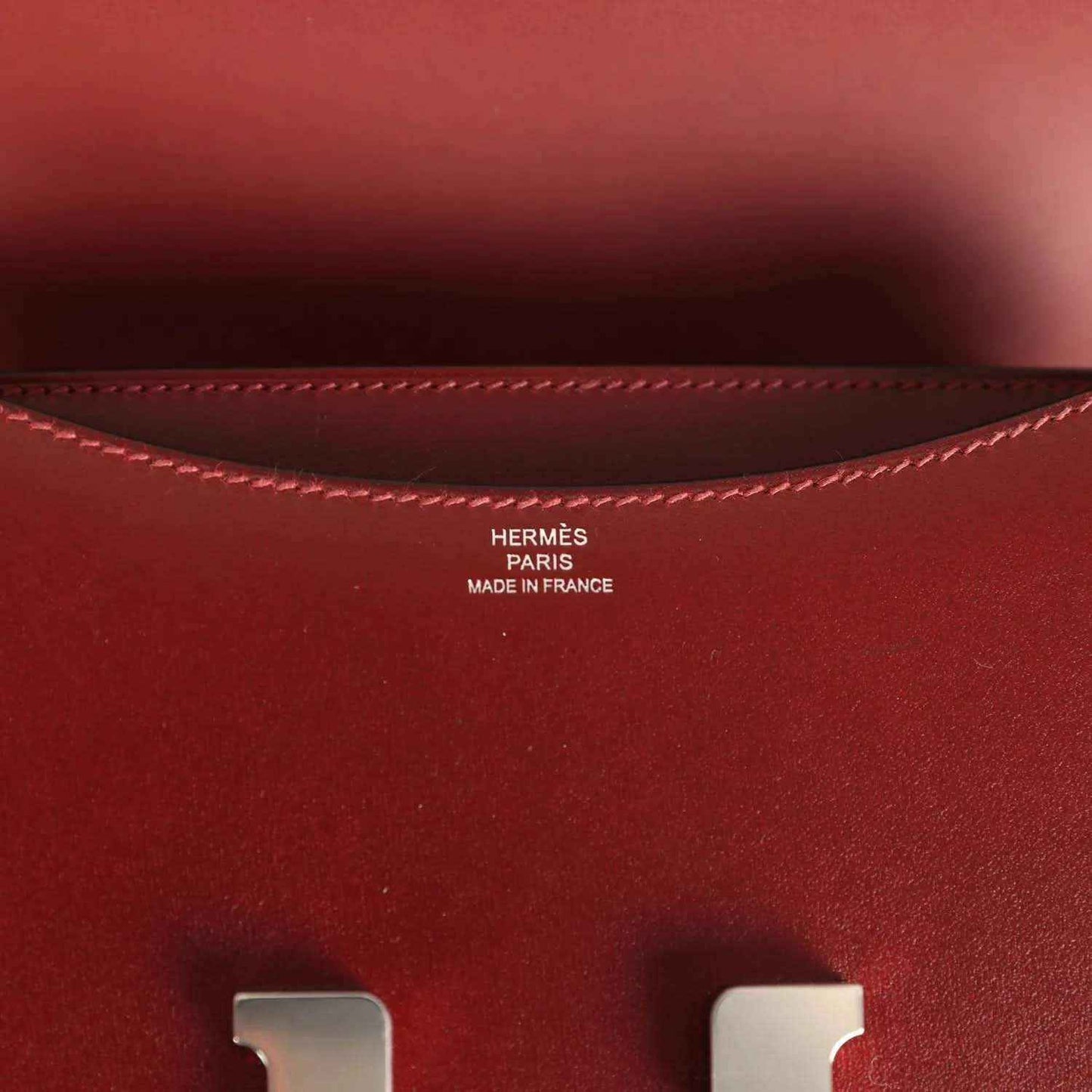 Burgundy leather interior with stitched edge and HERMÈS Paris Made in France stamp.