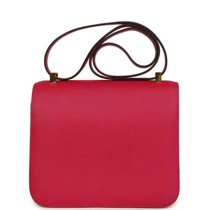 Red leather handbag with gold-tone clasp closure and top shoulder strap