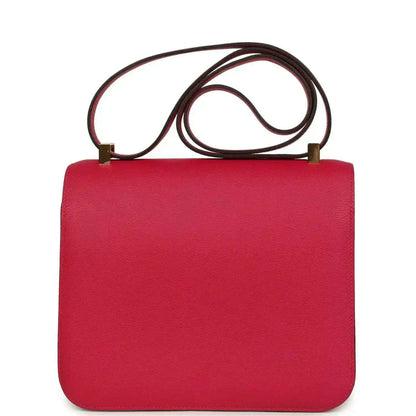 Red leather handbag with gold-tone clasp closure and top shoulder strap