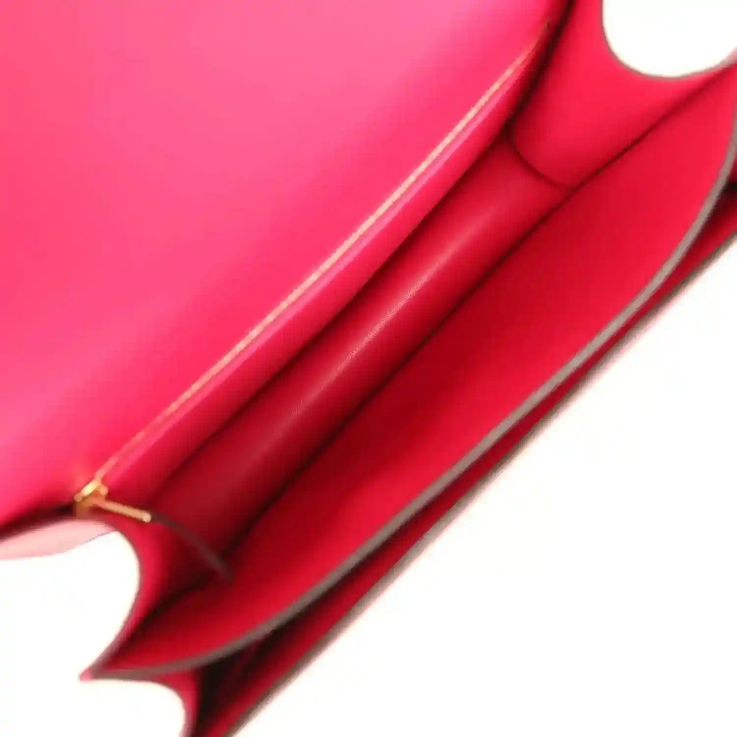 Red leather handbag interior with structured side panels and top stitching