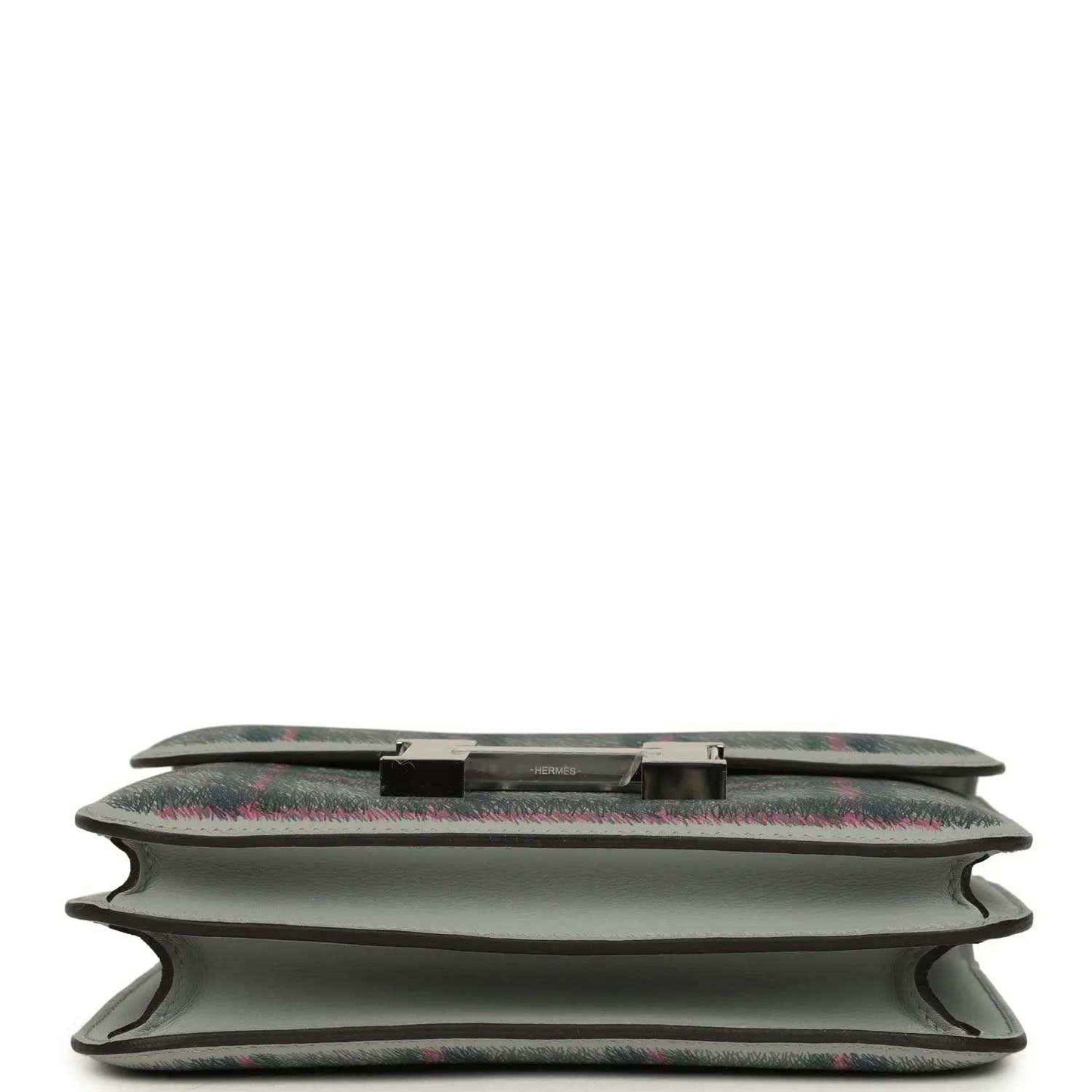 Tartan plaid leather handbag base detail with snap trim and folded edges