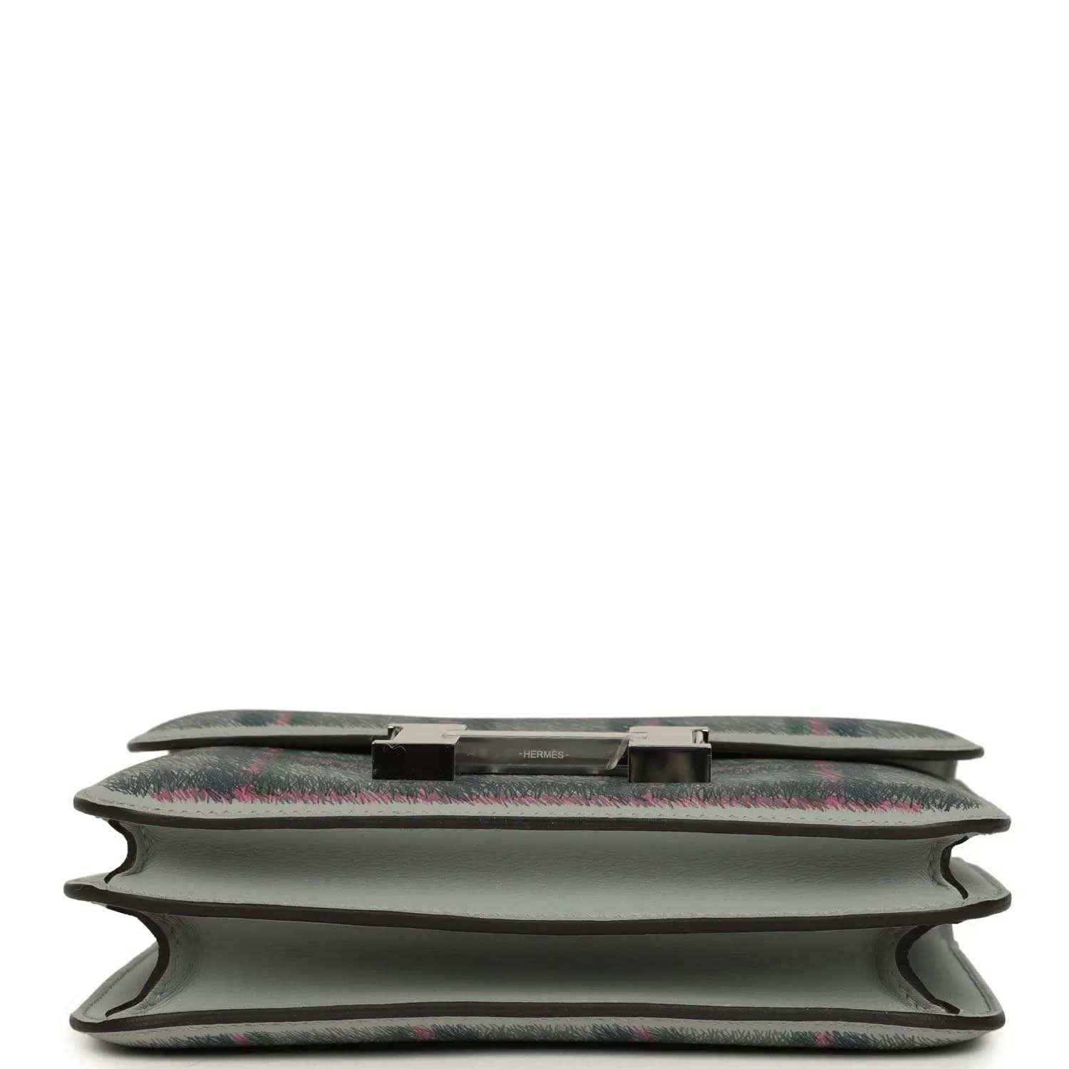Tartan plaid leather handbag base detail with snap trim and folded edges
