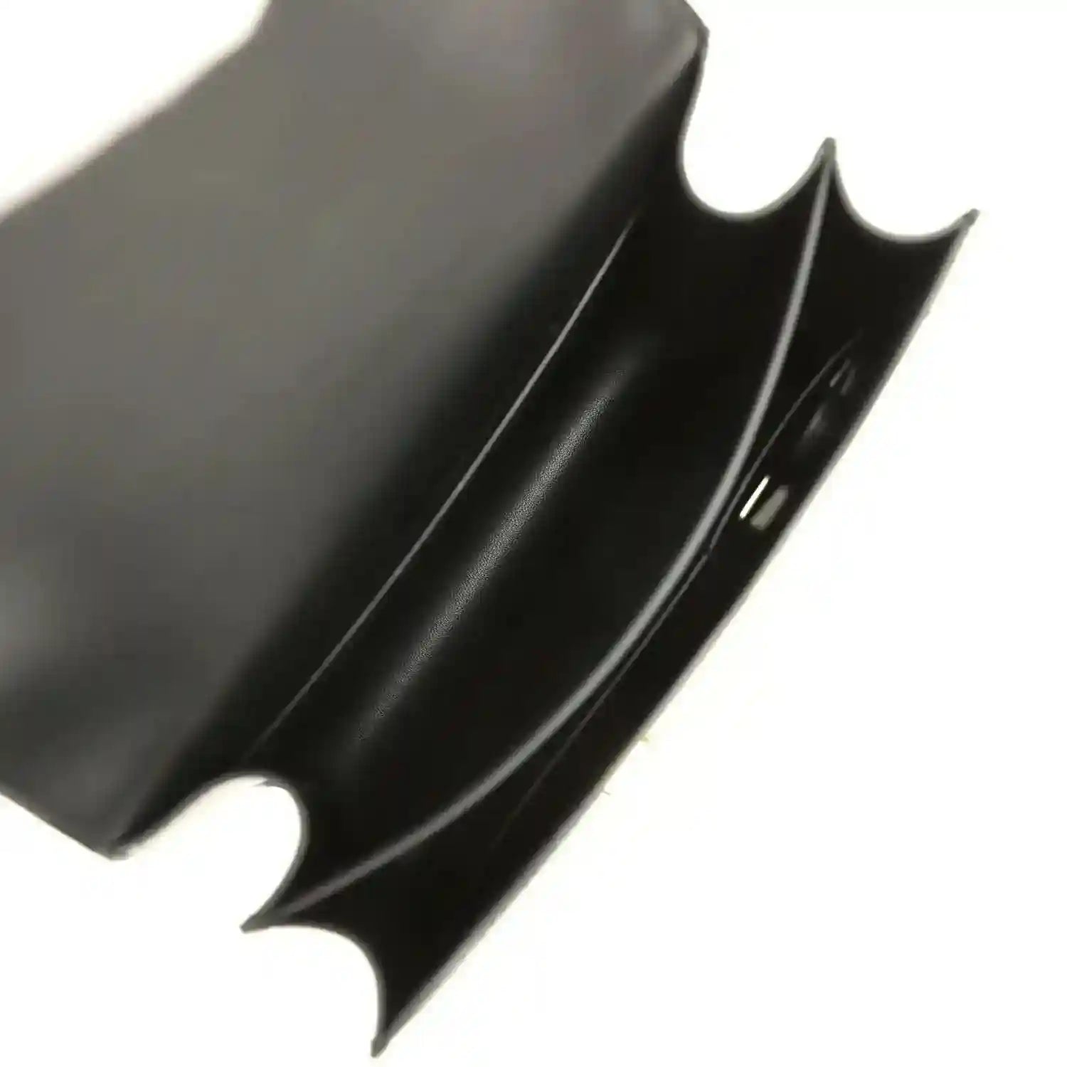 Black leather handbag interior corner with curved cutout and smooth lining