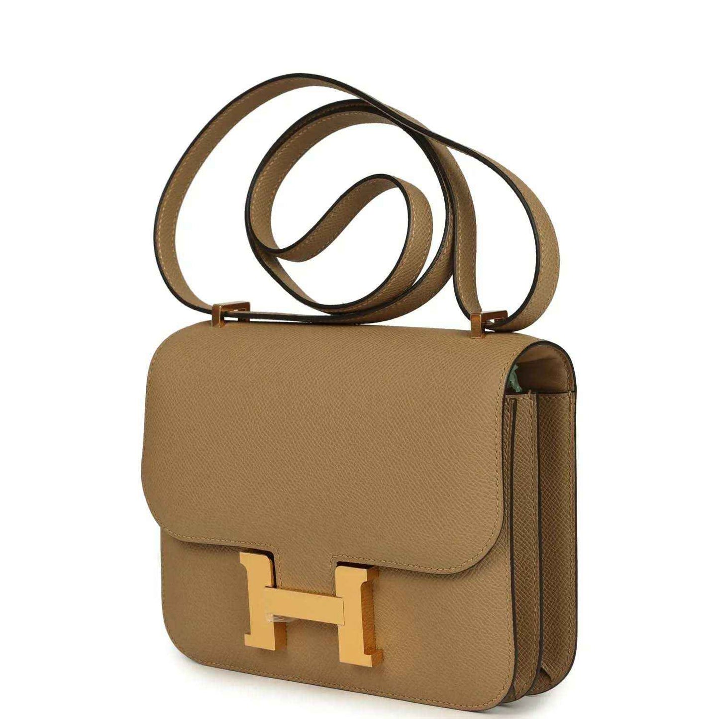 Tan leather crossbody bag with front flap, gold H clasp, side view with strap