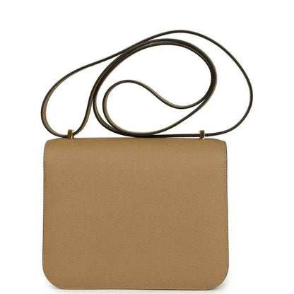 Tan leather crossbody bag with back view flap and gold-tone closure hardware, strap