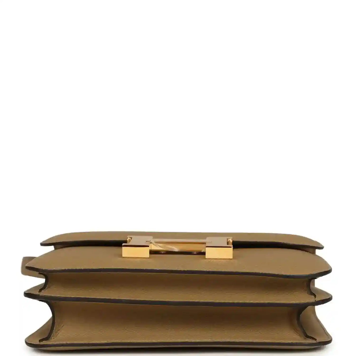 Tan leather bag underside with gold-tone hardware details and protective corner feet