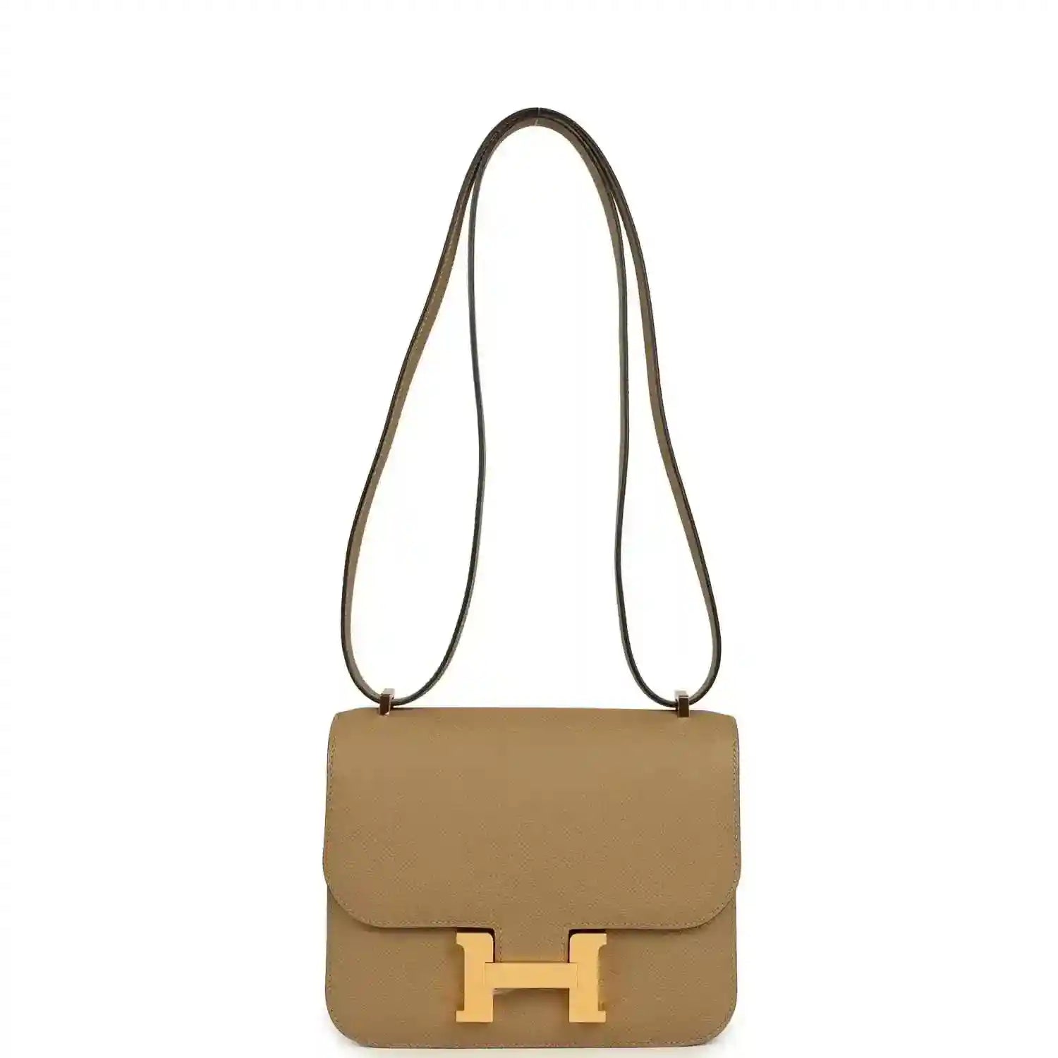 Tan leather mini crossbody bag with front flap and gold H clasp, long strap