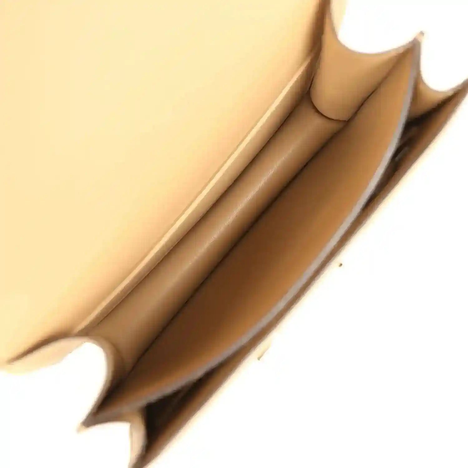 Tan leather interior with stitched lining and structured corner, gold-tone edges