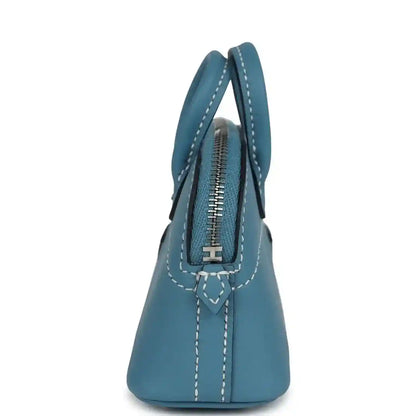 Hermes shark bag charm in blue leather, side view with zipper track and stitched handles