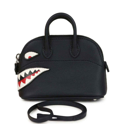 Black mini bag charm with top handles, shark mouth applique, and attached strap