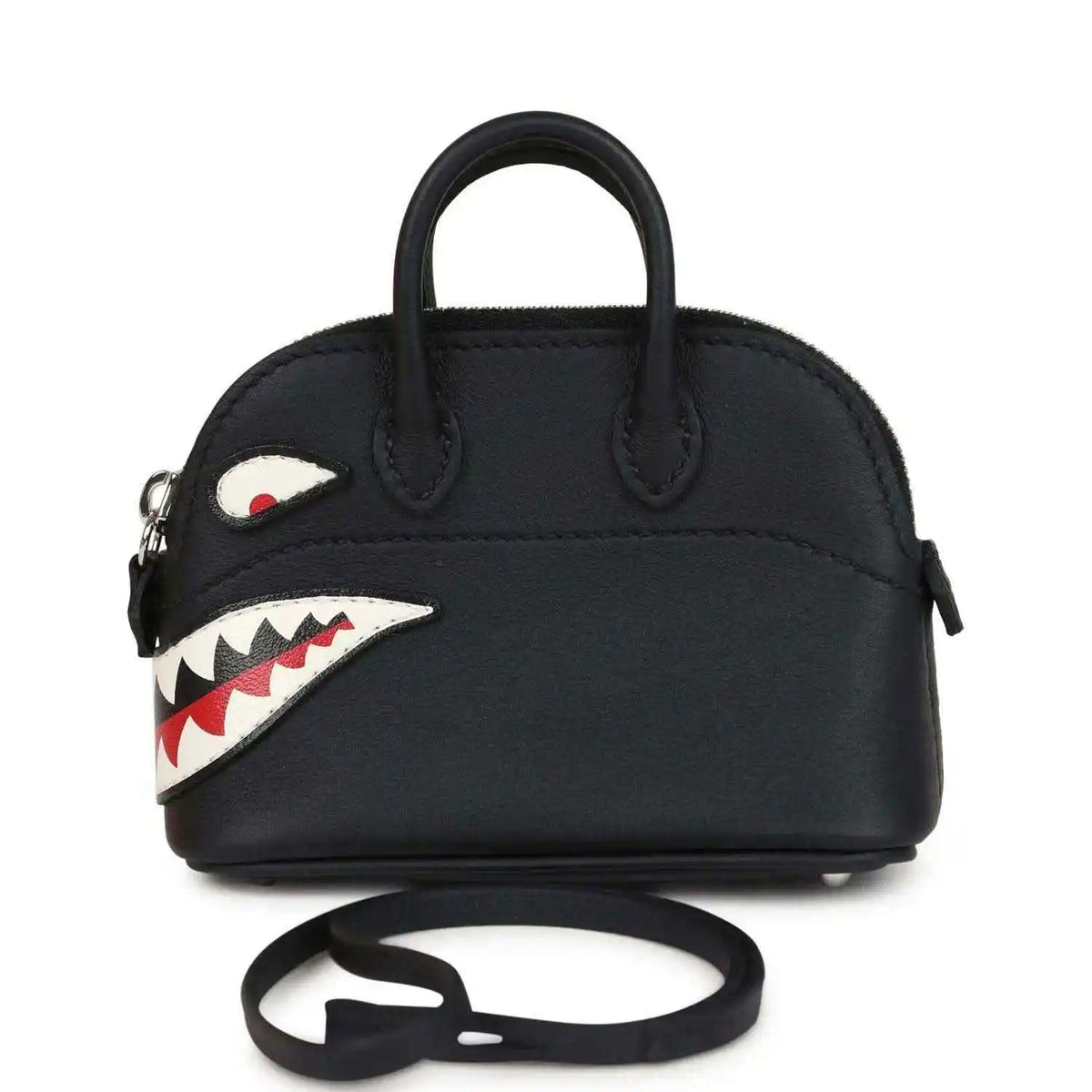 Black mini bag charm with top handles, shark mouth applique, and attached strap