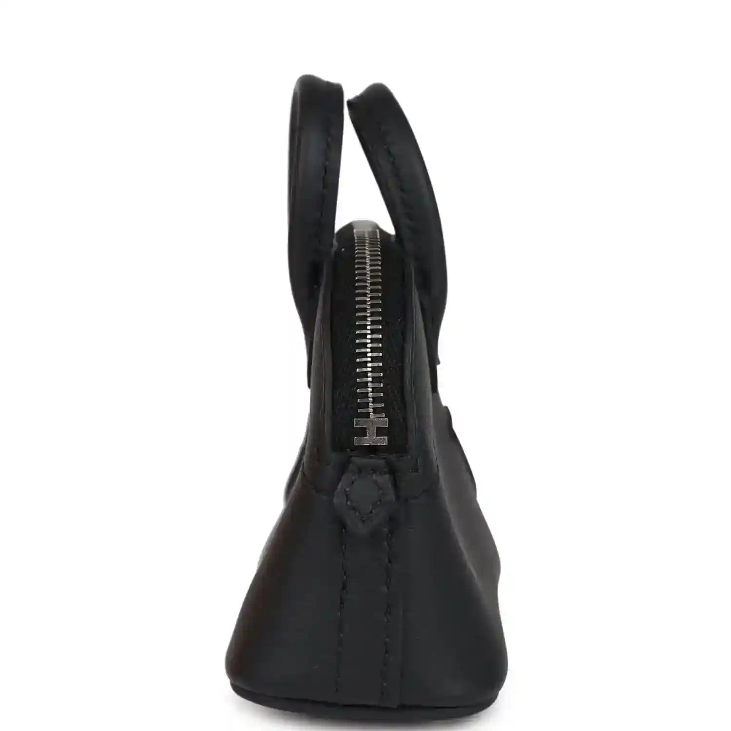 Black mini bag charm showing zipper track and stitched handle area