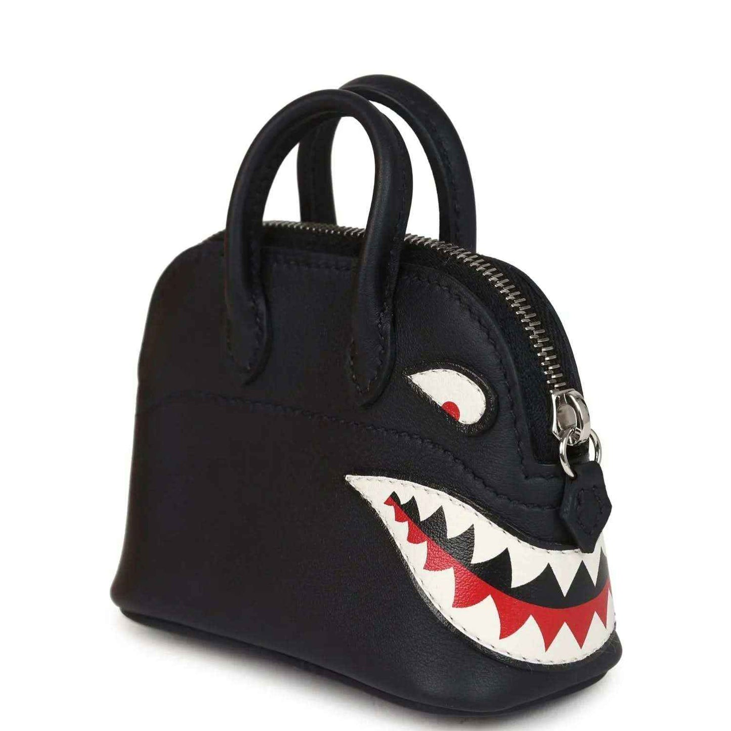 Black mini bag charm with top handles, gold zipper, shark mouth applique and eye patch