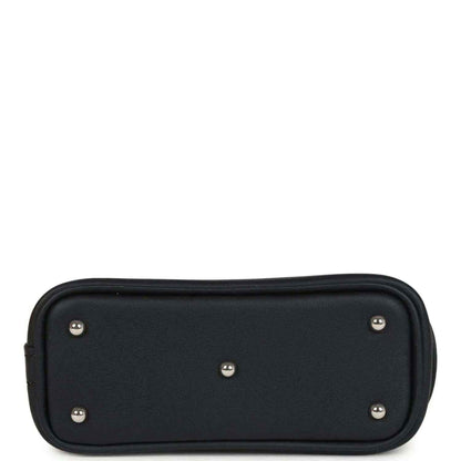 Black mini bag charm back panel with five metal studs and rounded shape
