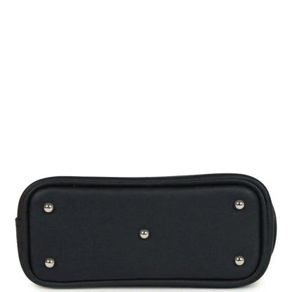 Black mini bag charm back panel with five metal studs and rounded shape