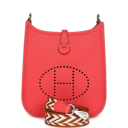 Red leather mini handbag with perforated E logo patch and top handle.