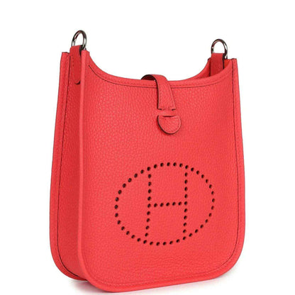 Red leather mini handbag with perforated E logo front and top handles.