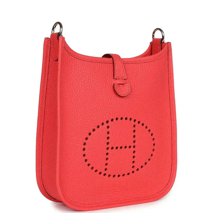 Red leather mini handbag with perforated E logo front and top handles.