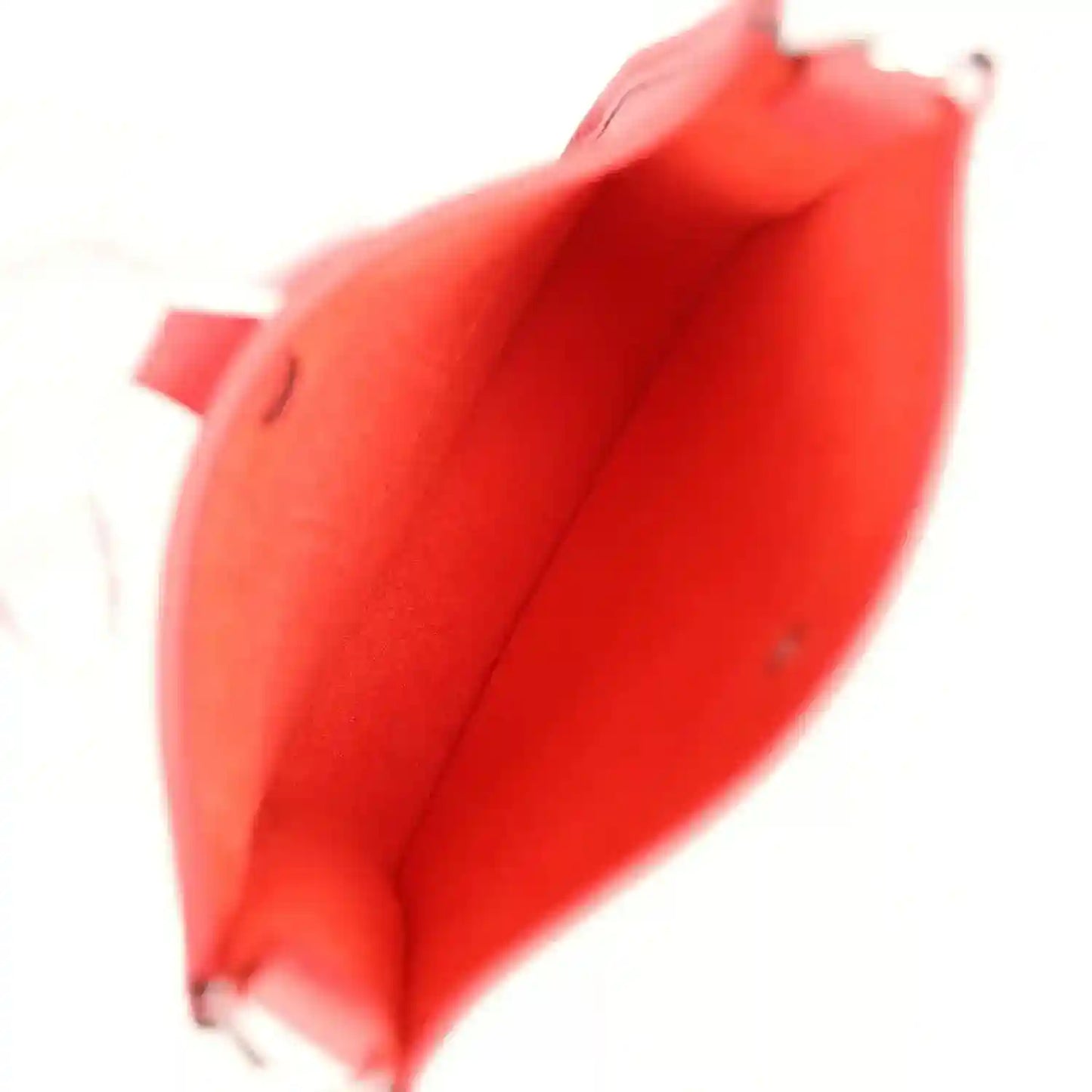 Red leather handbag interior view with open top and matching red lining.