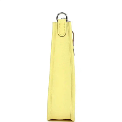 Lemon-yellow leather shoulder bag side view with vertical strap loop