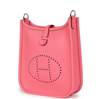 Pink Clemence leather Evelyne TPM crossbody bag with perforated logo, angled front