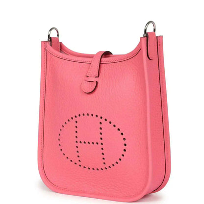 Pink Clemence leather Evelyne TPM crossbody bag with perforated logo, angled front