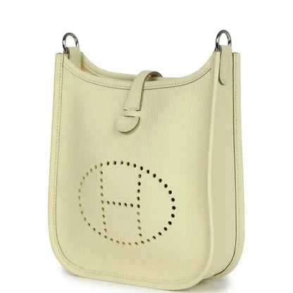 Light yellow leather mini crossbody bag with perforated 'E' logo on front