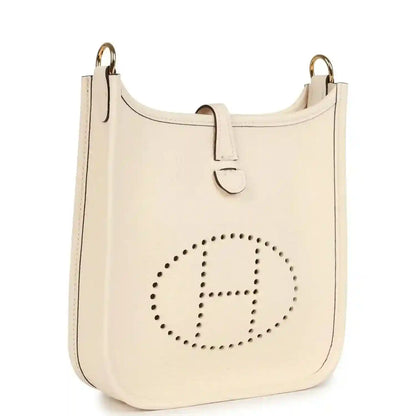 Light beige TPM bag with perforated 'E' logo, front panel and gold-tone hooks