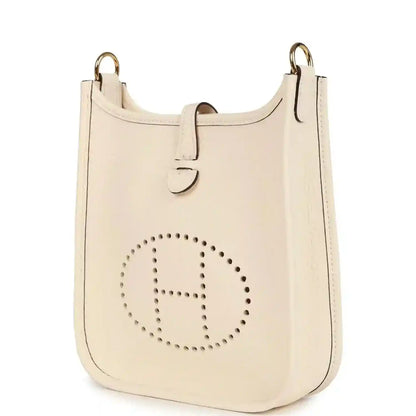 Light beige TPM bag with perforated 'E' logo and gold-tone top rings