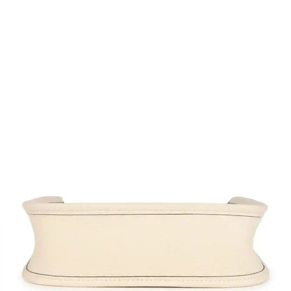 Light beige TPM bag side view with wide top trim and slim strap loops