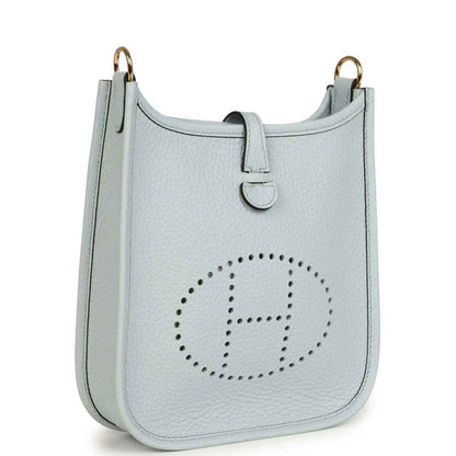 Evelyne TPM bag in pale blue grained leather with front logo and dual top handles