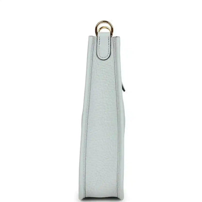 Evelyne TPM bag in pale blue grained leather, tall side view with top loop handle