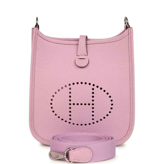 Mauve-pink leather crossbody bag with perforated logo and front snap strap charm