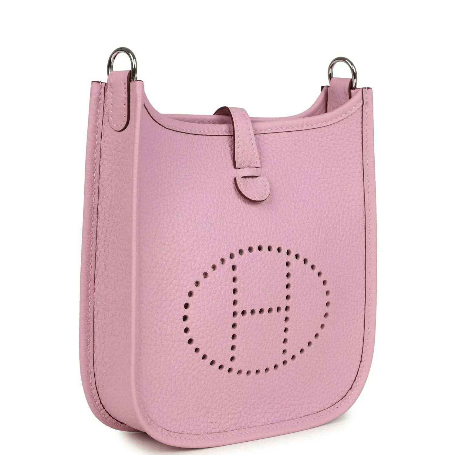 Mauve-pink leather crossbody bag with perforated front logo and top ring handles