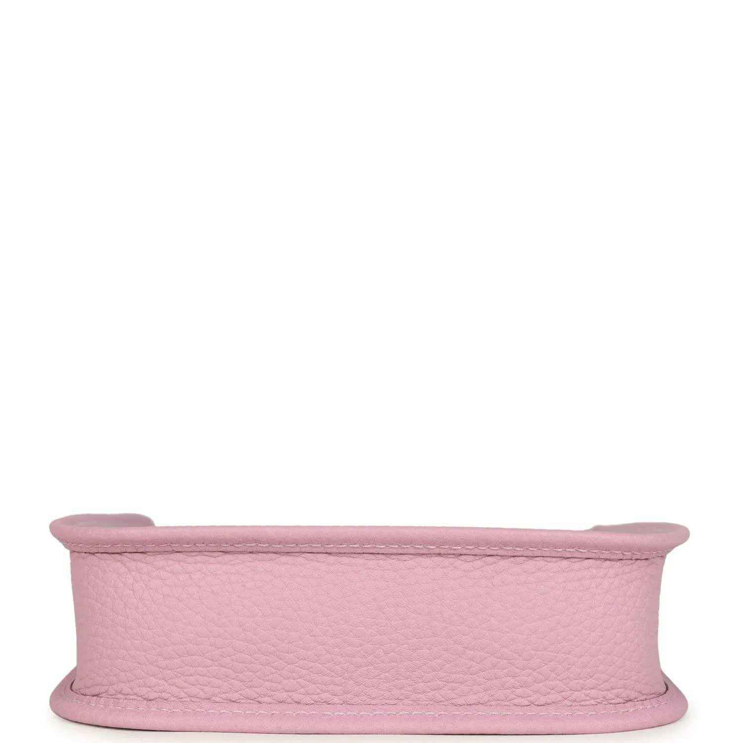 Mauve-pink leather crossbody bag side profile showing wide strap and curved top edge