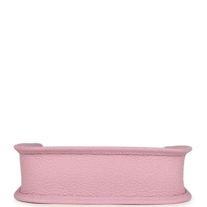 Mauve-pink leather crossbody bag side profile showing wide strap and curved top edge